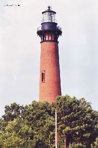 Currituck Beach Light rises high above the trees.