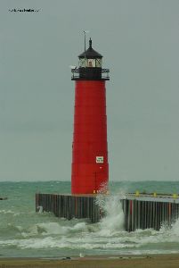 Waves slam against the breakwall.