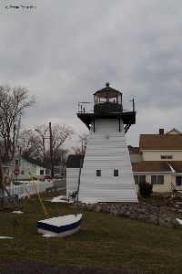 Olcott Lighthouse with a boat in the photo.