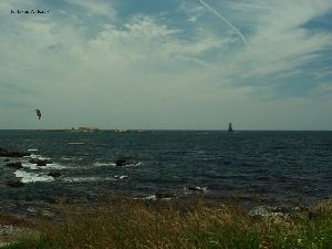 Someone parasailing by the tower.